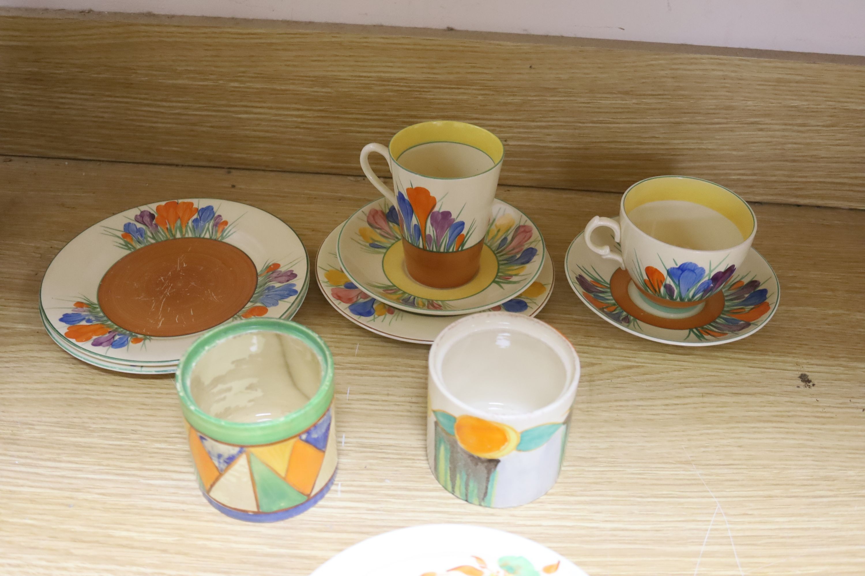 A quantity of Clarice Cliff pottery, Including Crocus pattern tea wares, two preserve jars missing Lids, a plate and three bowls